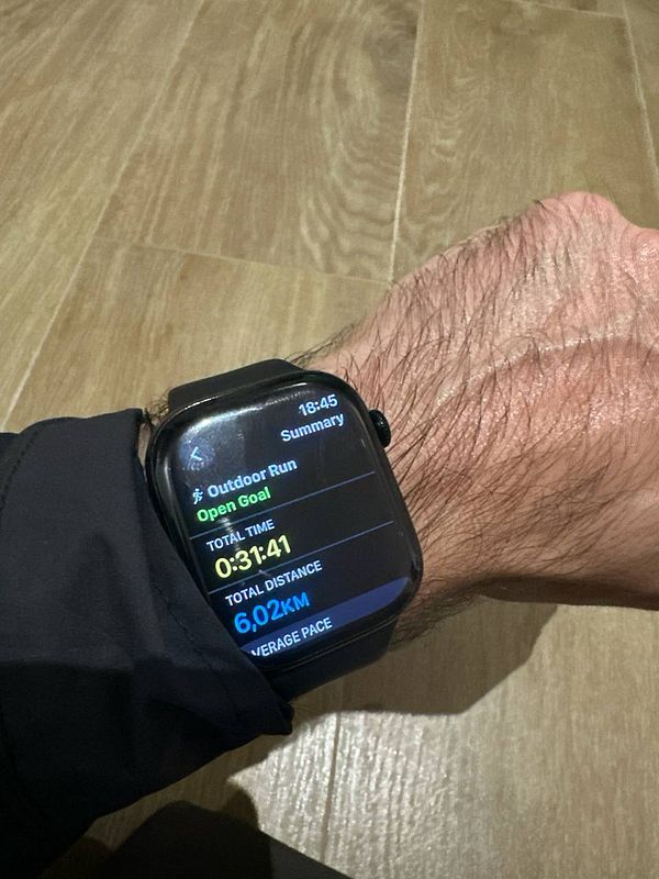 A smartwatch displays running statistics after completing a 6 km outdoor run.