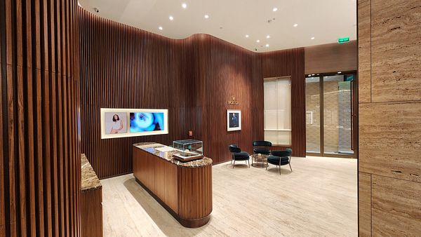 A luxurious interior of a new Rolex boutique featuring elegant wooden paneling and modern decor.