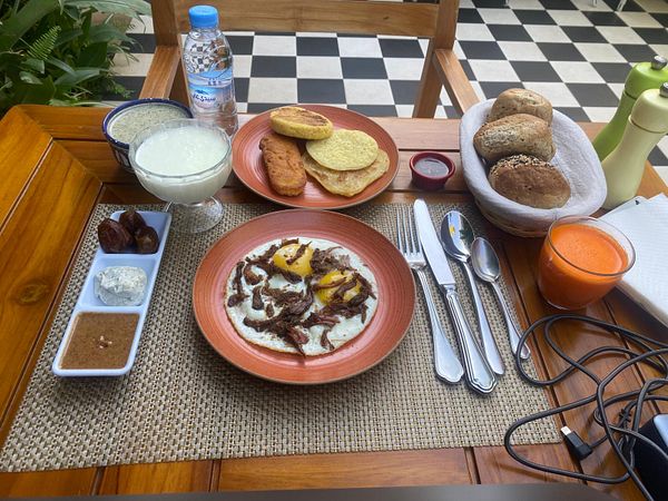 A beautifully arranged Moroccan breakfast spread on a wooden table.