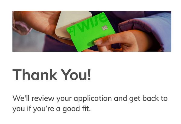 A person is holding a green Wise card while a thank you message is displayed below.