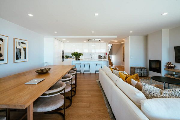 A modern, open-concept living and dining area featuring stylish furniture and decor.