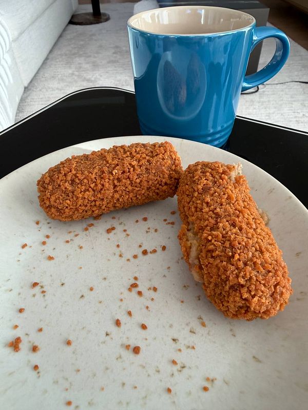 Close-up image of several Dutch krokets, showcasing their golden-brown breadcrumb coating.