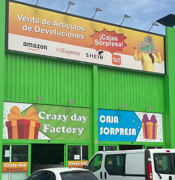 A vibrant storefront advertising a return sale market featuring major online retailers.