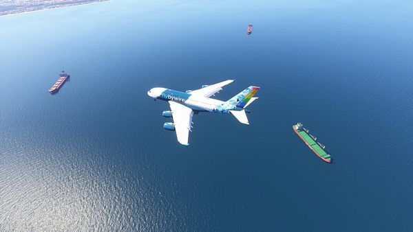 An airplane flies over the ocean near Cape Town, surrounded by cargo ships.
