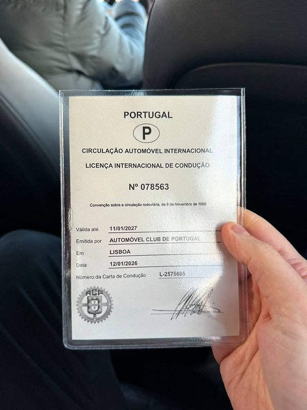 Close-up image of an International Driving Permit booklet opened to a page showing driving permits for multiple countries.