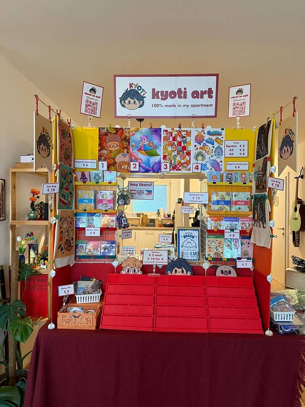 A colorful art display featuring various handmade items and artwork for sale.