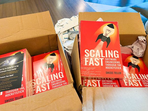 A box filled with preprint copies of a book titled 'Scaling Fast'.
