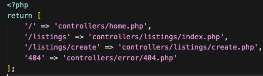 The image displays a PHP code snippet defining routing for a web application.