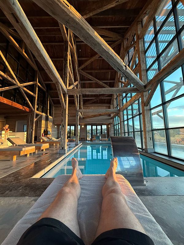 A serene indoor pool area with wooden architecture and a relaxing atmosphere.