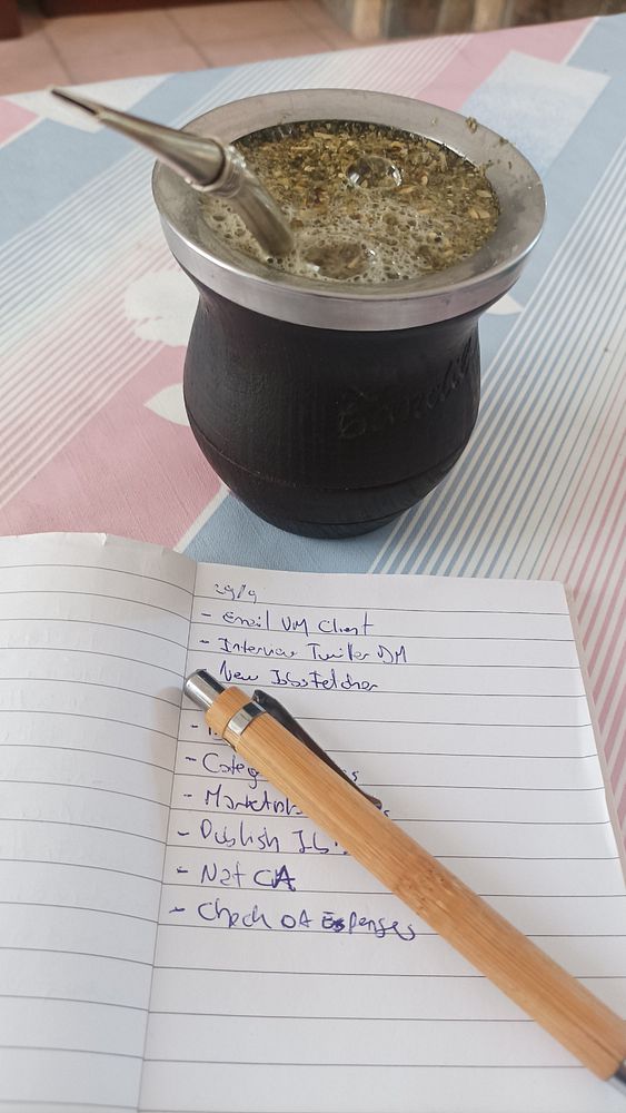 A mate drink and a to-do list are displayed on a table.