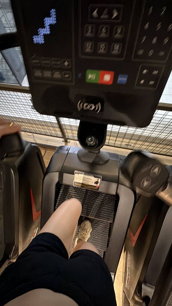 Photograph of a person lifting weights in a gym.