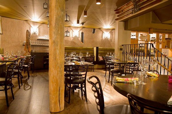 A stylish restaurant interior featuring elegant dining arrangements and warm lighting.