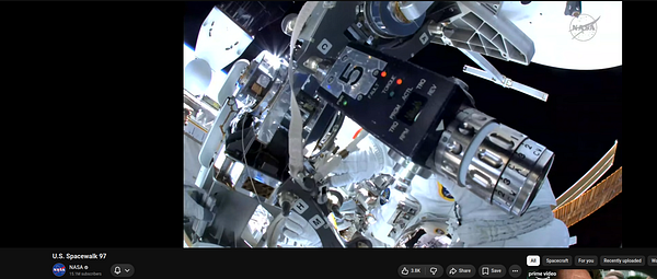 NASA live spacewalk broadcast showing a timer and astronaut outside the spacecraft.