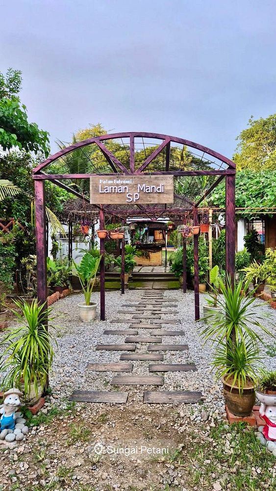 A charming outdoor pathway leads to a welcoming entrance of a garden area.