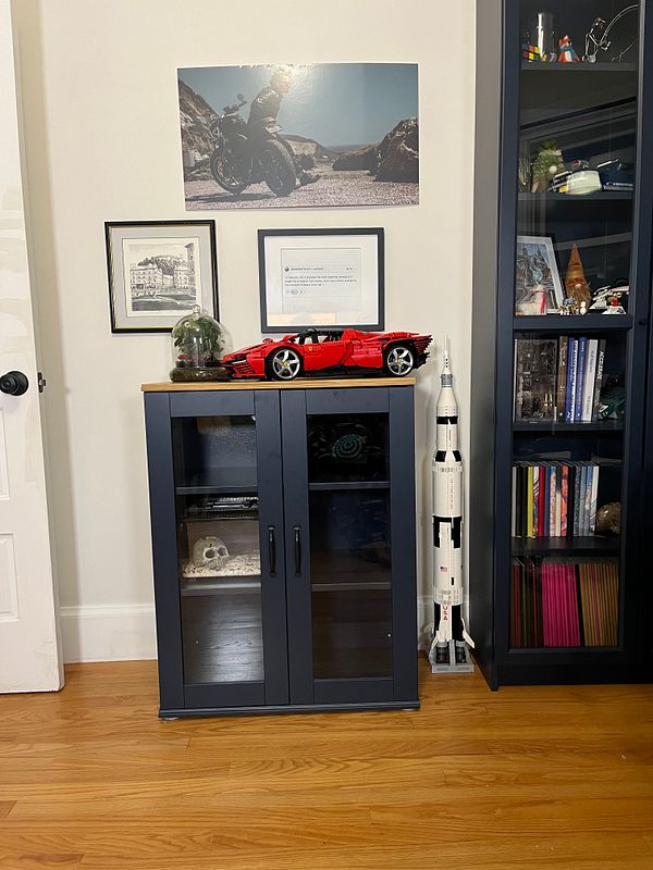 A modern cabinet setup featuring decorative items and a striking wall art piece.