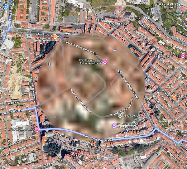 A blurred satellite map of a section of Lisbon, highlighting various streets and landmarks.