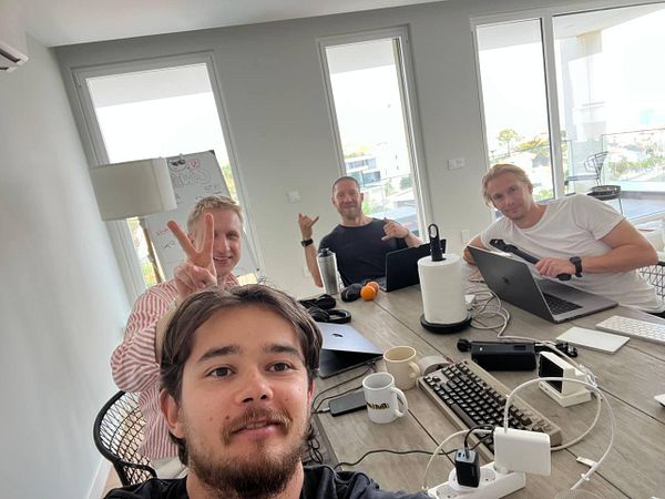 A group of four individuals is gathered around a table for a coworking day.