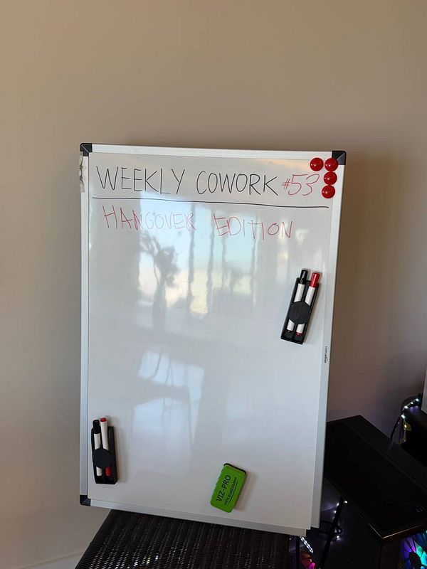A lively indoor coworking session with diverse participants focused on work and collaboration.