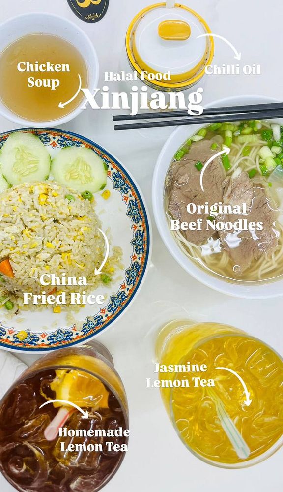 A vibrant spread of Xinjiang halal food featuring various dishes and drinks.