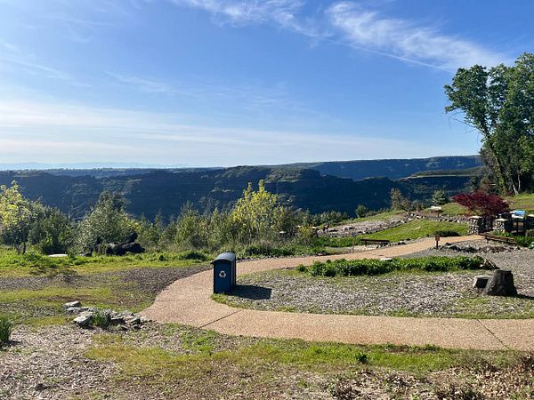 A scenic view of a park area in North California with a vast canyon in the background.
