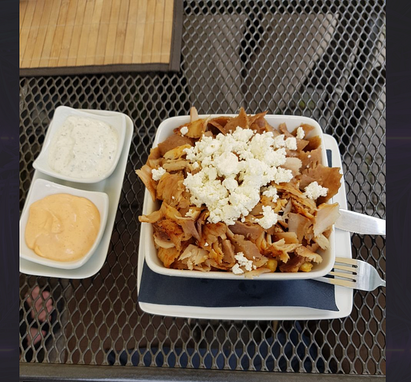 A delicious serving of Döner with sauces on a table.