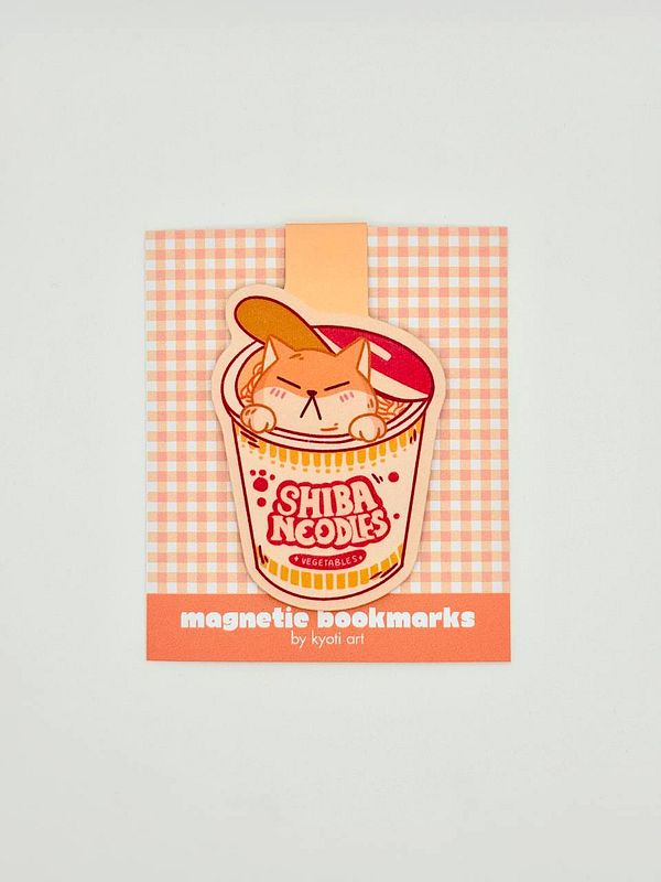 A colorful packaging design for magnetic bookmarks featuring a cartoon cat in a noodle cup.