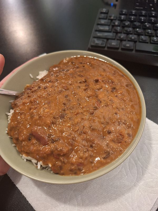 A bowl of dal makhani served over basmati rice.
