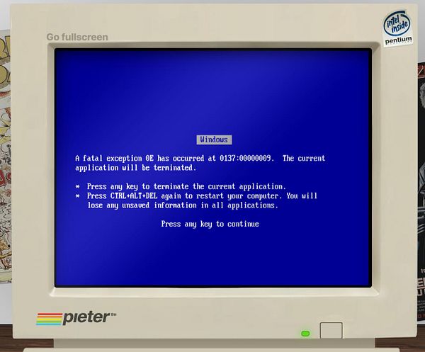 A vintage computer monitor displays a blue screen error message.