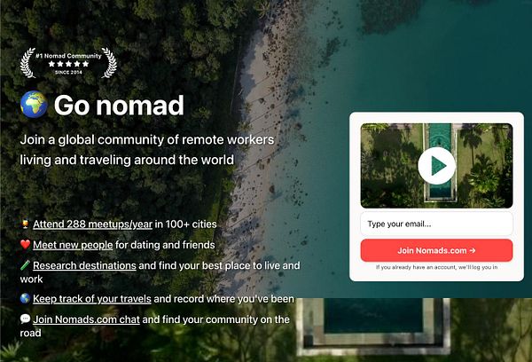 Travelers with backpacks walking on a rocky mountain path under a blue sky with clouds, overlooking a valley and distant hills.