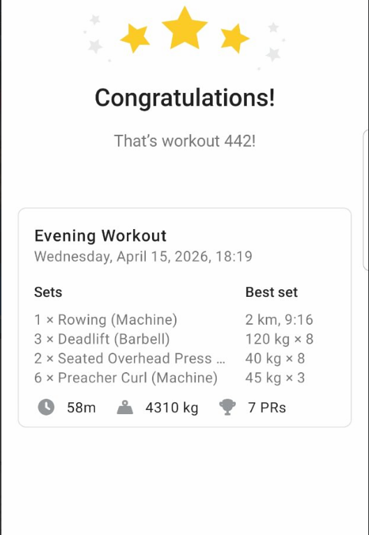 A bright gym room with large windows showing snowy mountains and people exercising on various machines.