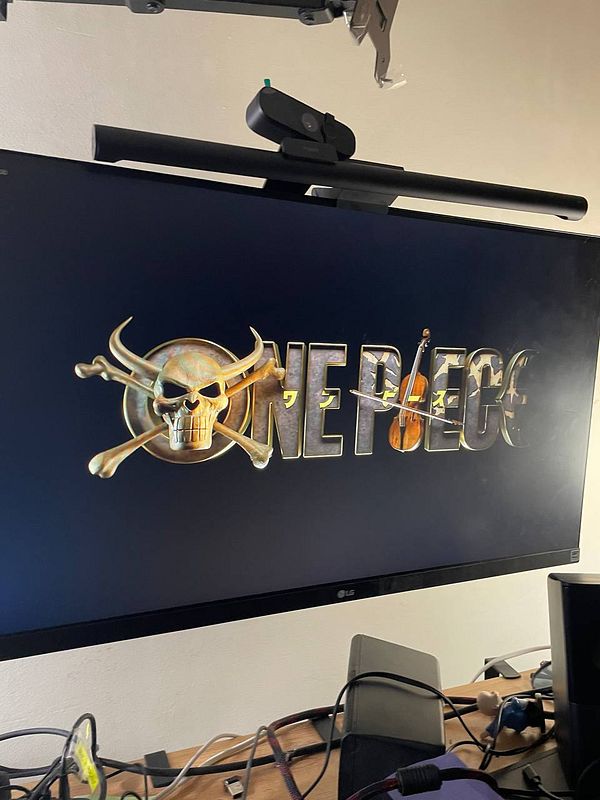 Poster image for the live action One Piece series featuring main characters against a dark, eerie background.