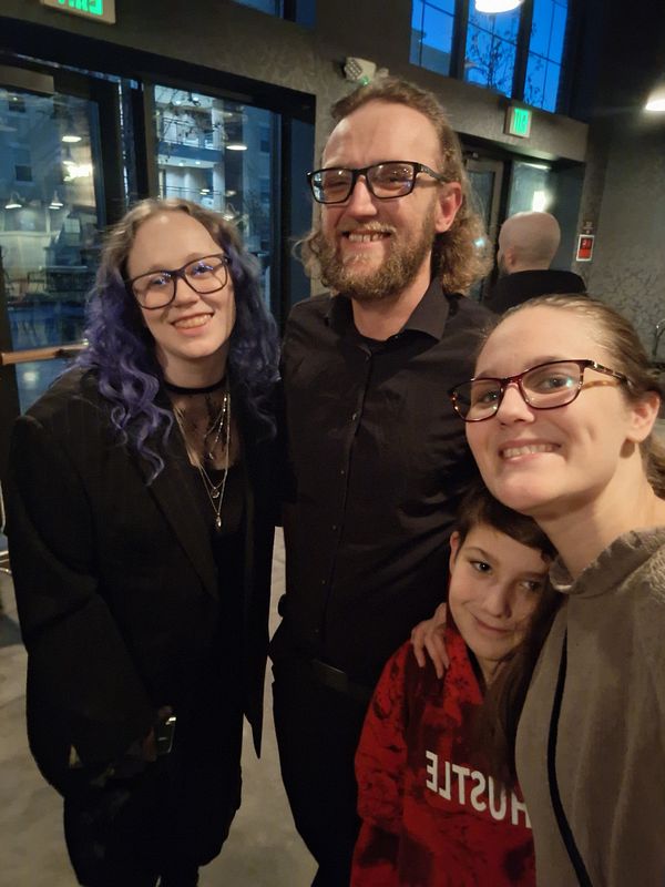 A group of friends poses together in a celebratory setting.