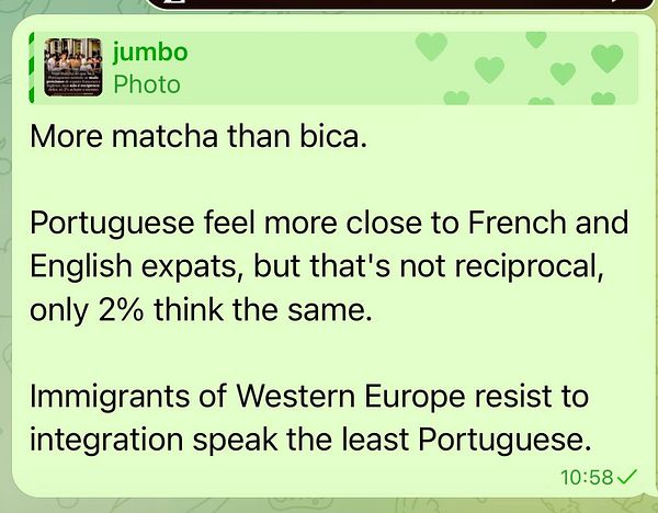 Image of a large commercial cargo ship docked at a port with cranes loading or unloading containers.