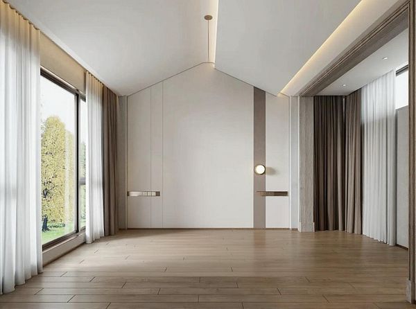 A spacious, empty room with large windows and modern design elements.
