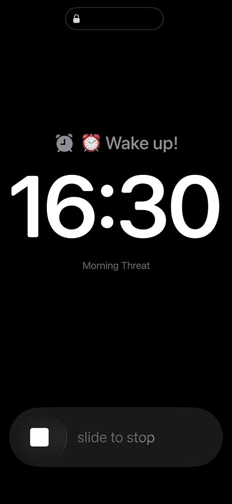 Photo of an alarm clock showing the time 7:00 on a wooden floor background.
