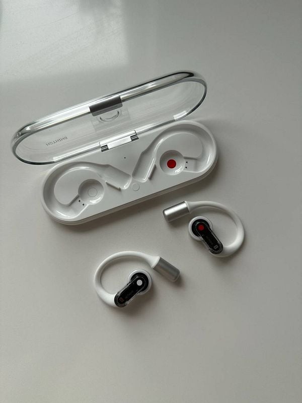 The image features a pair of Nothing earpods and their charging case.
