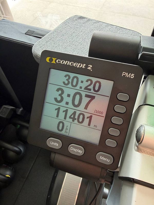 Photo of a person jogging on a treadmill in a gym with card readers and TV screens visible.