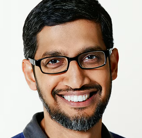 A smiling man with glasses and a beard is featured in the image.