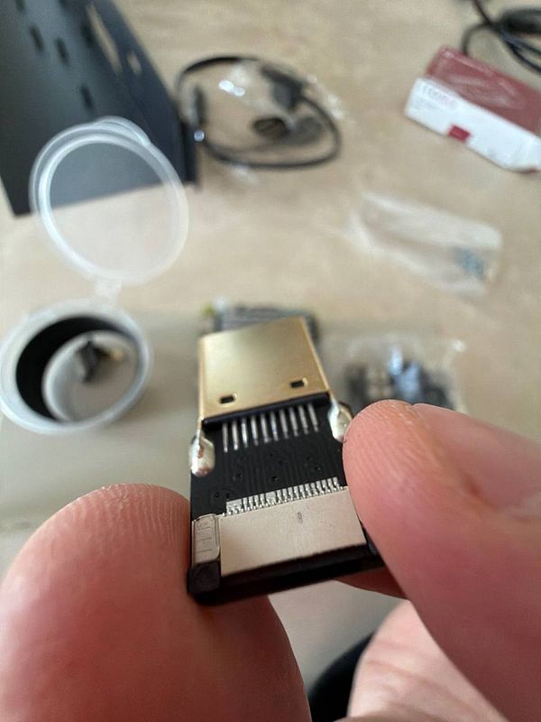 A close-up view of a USB device being held between fingers.