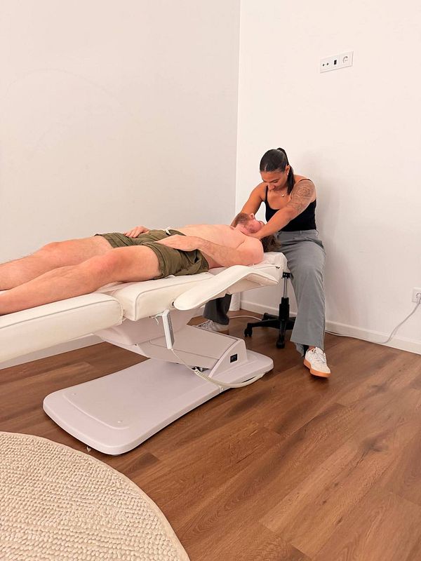 Illustration of an arm with detailed muscular anatomy highlighting a pressure point relevant for painful massage therapy.