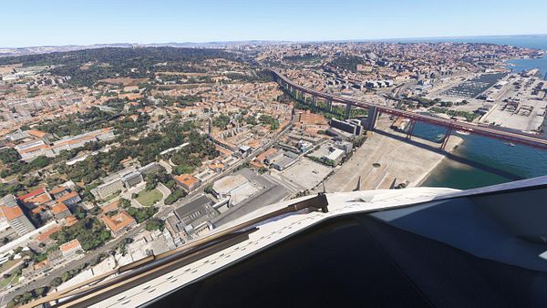 Aerial view of Lisbon with a focus on the cityscape and waterfront.