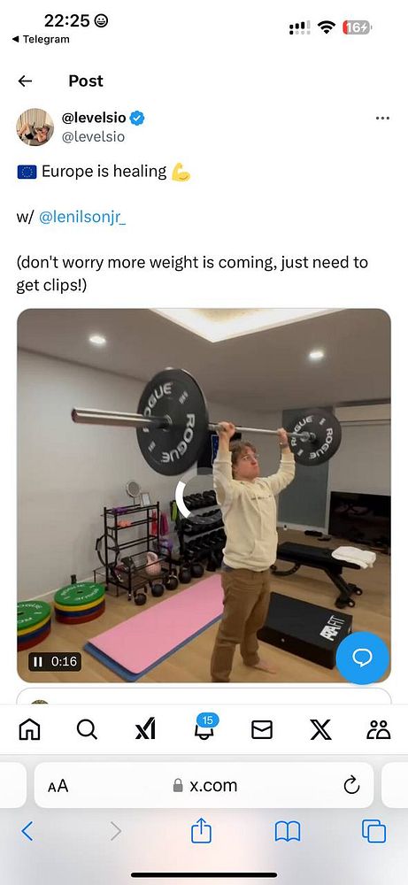A person is lifting a barbell in a home gym setting.