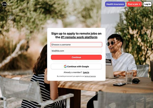 A user registration interface for a remote job platform is displayed in an outdoor setting.