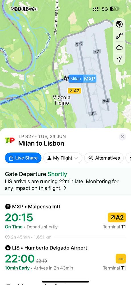 The image displays a flight status interface showing a delayed flight from Milan to Lisbon.