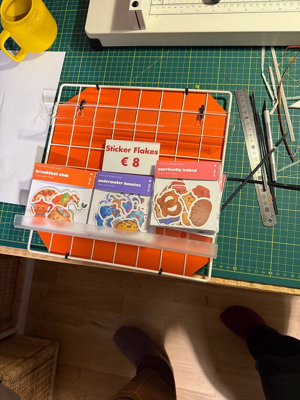 A workspace featuring a display of sticker flakes and crafting tools.