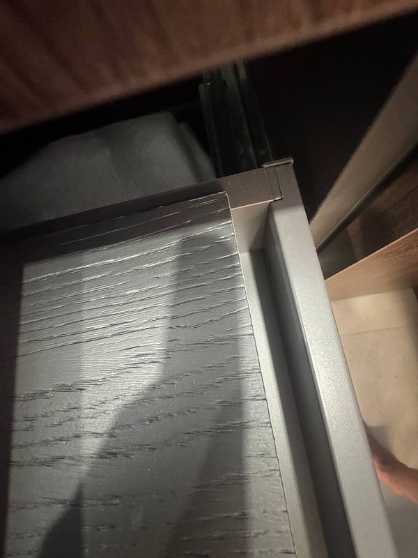 A close-up view of a drawer with a visible gap indicating a measurement error.