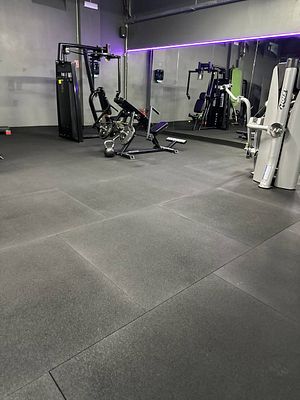 A modern gym interior featuring various exercise equipment.