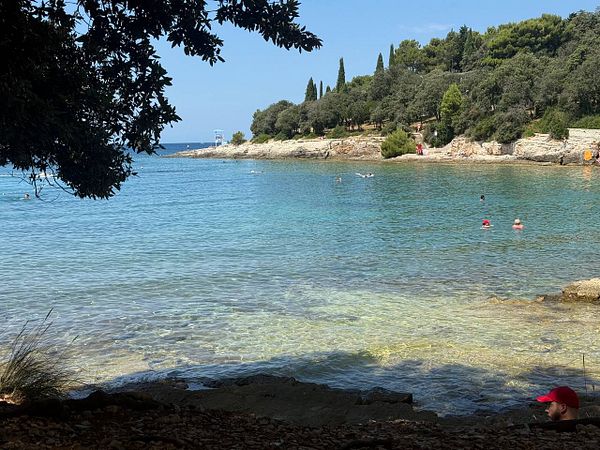 A serene beach scene in Croatia on a sunny day.