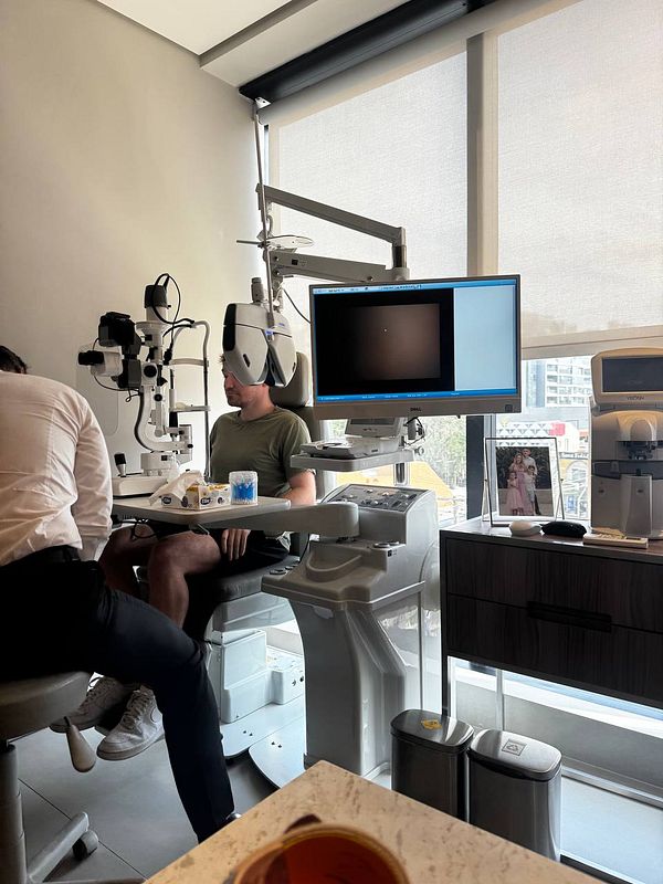 A patient is undergoing an eye checkup in a modern clinic setting.