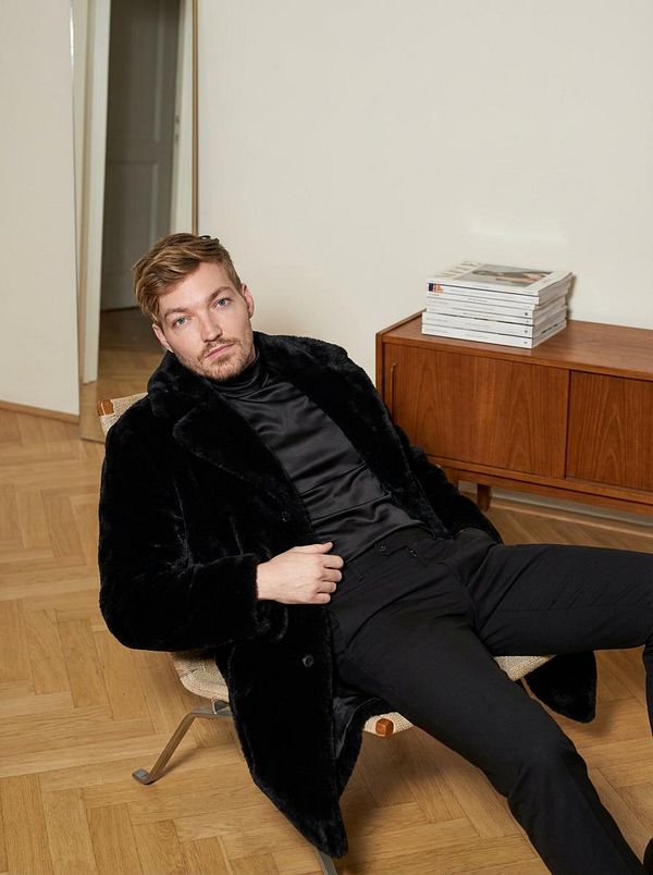 A surreal digital artwork featuring an astronaut with a crystal skull helmet surrounded by intricate abstract shapes and vibrant neon colors.